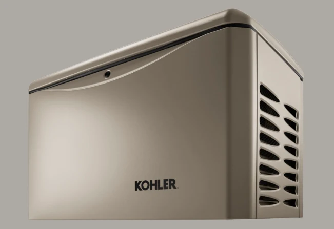 A metallic Kohler-branded generator with a curved top, side vent openings, and a smooth front panel, shown against a plain gray background.